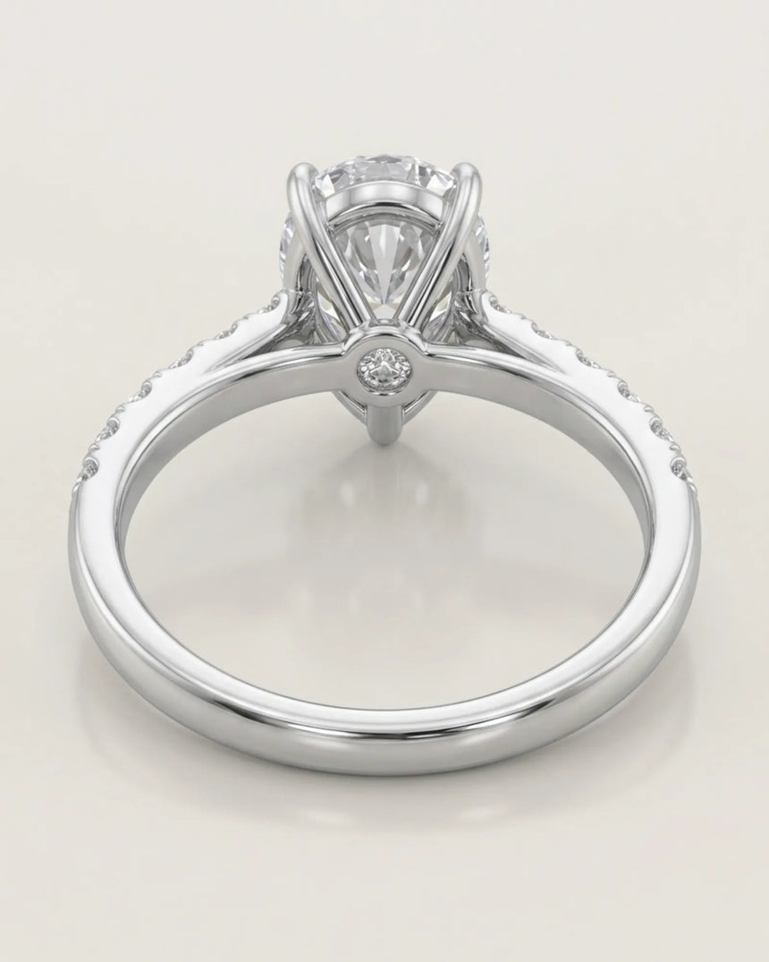 Luxury pear cut moissanite ring with sculptural gallery and luminous shoulder accents in platinum | SARATTI