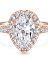 Luxury pear halo moissanite ring combining brilliant accents with warm rose gold elegance | SARATTI