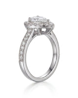 Luxury pear moissanite ring with halo, pavé band, and timeless platinum setting | SARATTI