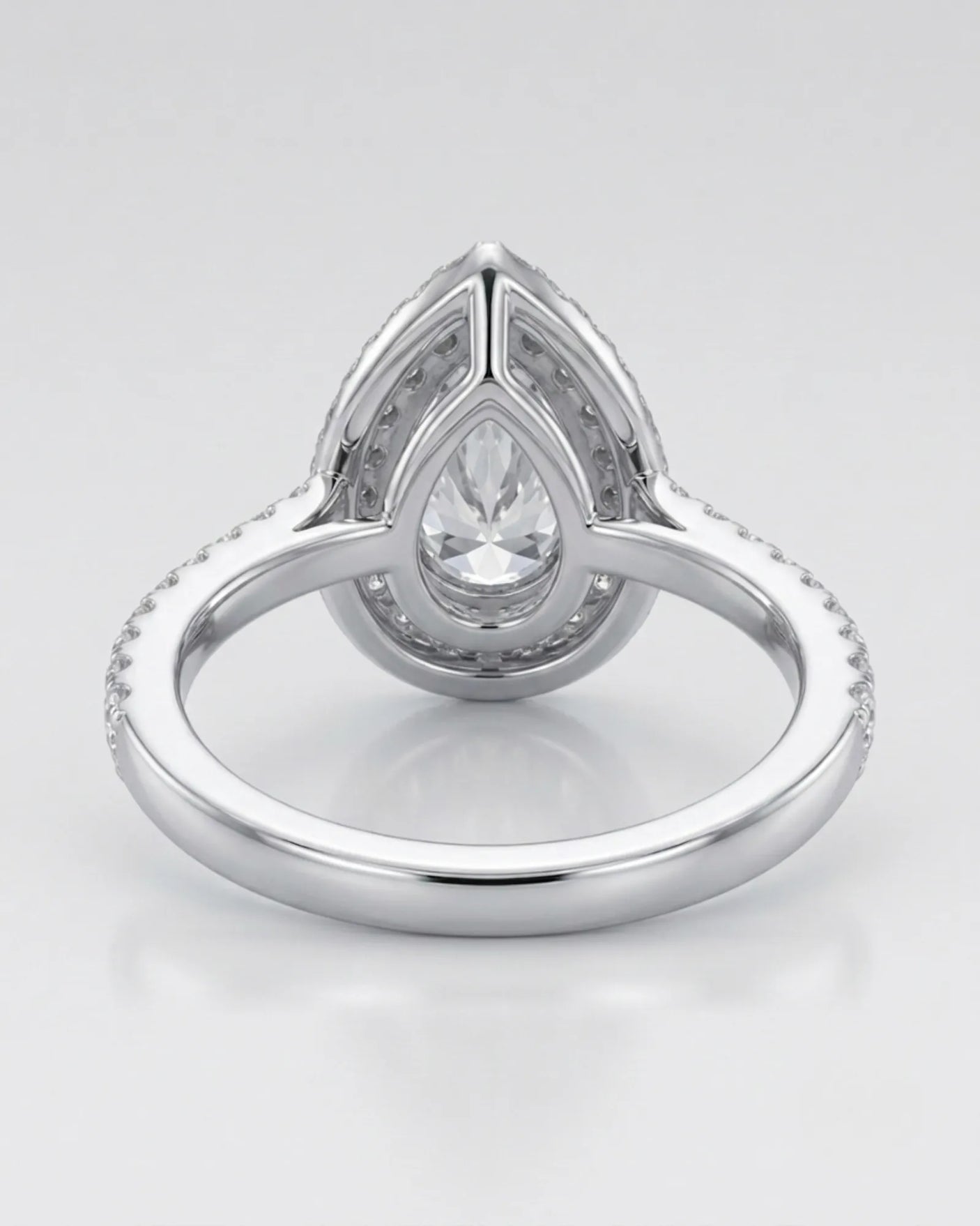 Luxury pear shaped moissanite ring with brilliant halo and pavé shoulders in 18K white gold - SARATTI