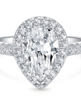 Luxury pear shaped moissanite ring with brilliant halo and pavé shoulders in 18K white gold | SARATTI