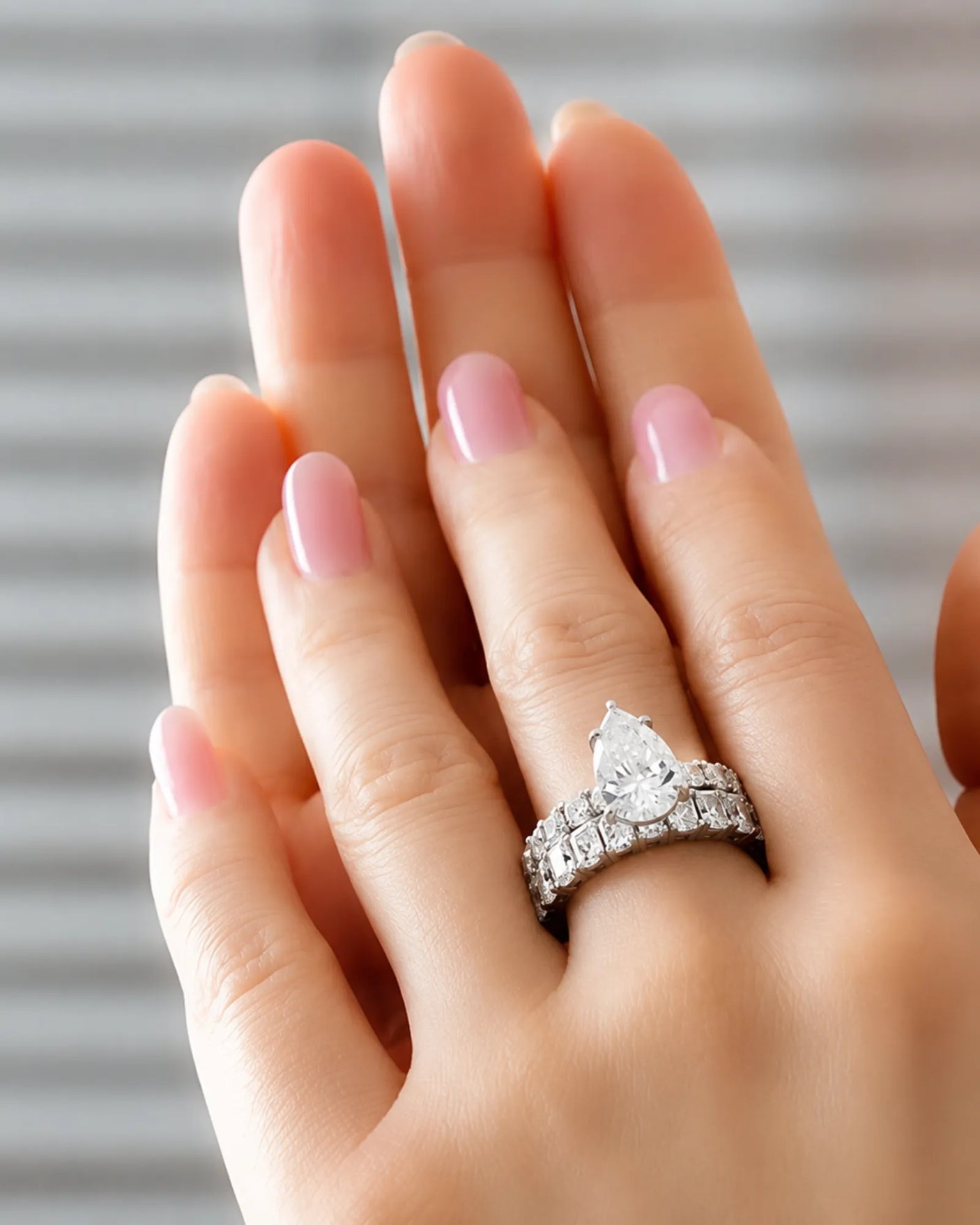 Luxury platinum pear cut moissanite ring with luminous side stones and elegant balance | SARATTI.