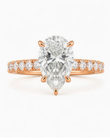 Luxury rose gold pear cut moissanite ring with luminous side stones and elegant balance | SARATTI