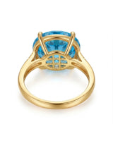 Luxury round blue topaz cocktail ring with diamond-accented shoulders in polished 18K yellow gold - SARATTI