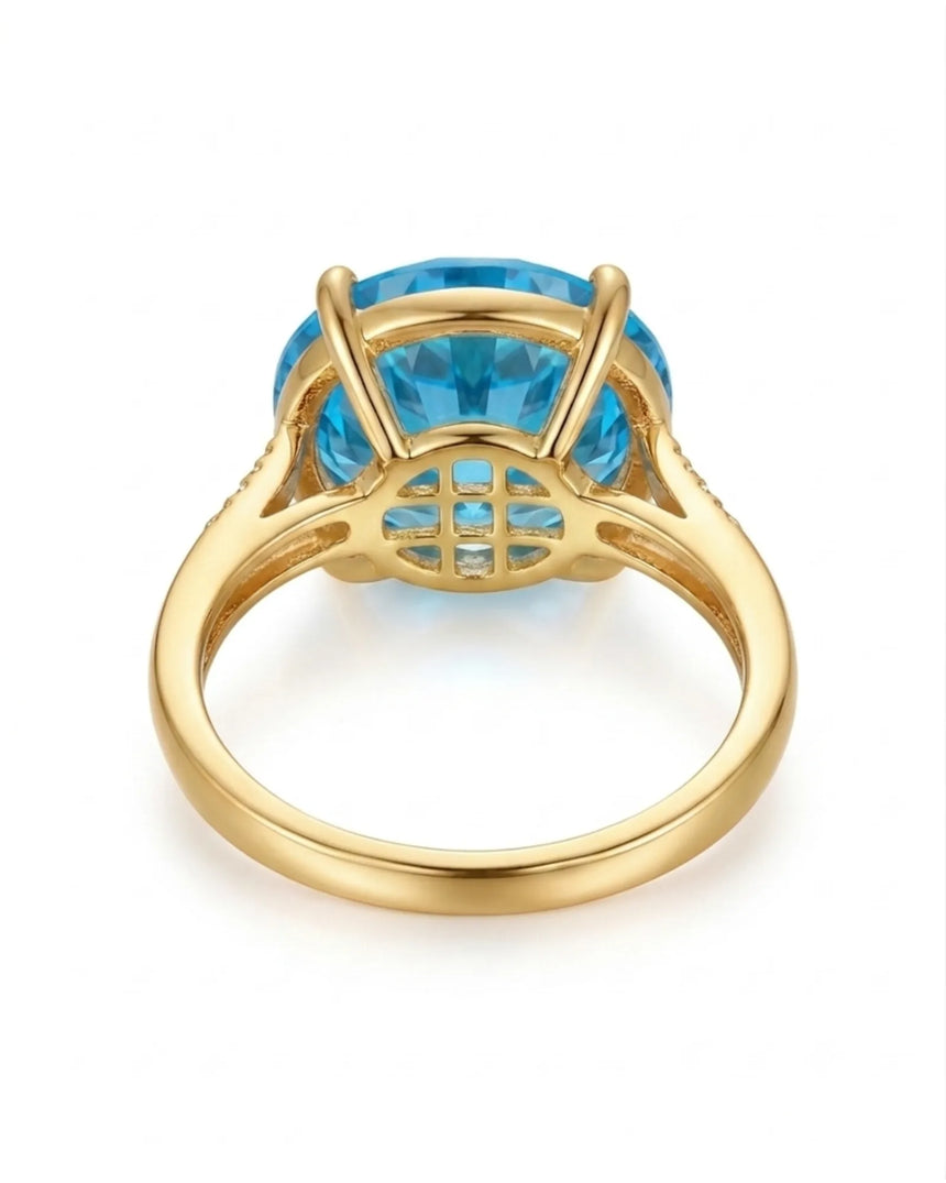 Luxury round blue topaz cocktail ring with diamond-accented shoulders in polished 18K yellow gold - SARATTI