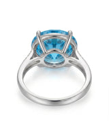 Luxury round blue topaz cocktail ring with diamond-accented shoulders in substantial platinum - SARATTI