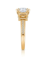 Luxury round moissanite ring with pavé accents and ornamental fleur-de-lis gallery crafted in 18K yellow gold | SARATTI