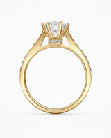 Luxury round moissanite ring with sculptural prongs and warm yellow gold finish | SARATTI