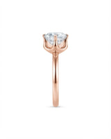Luxury round moissanite solitaire in 18K rose gold with refined architectural setting | SARATTI