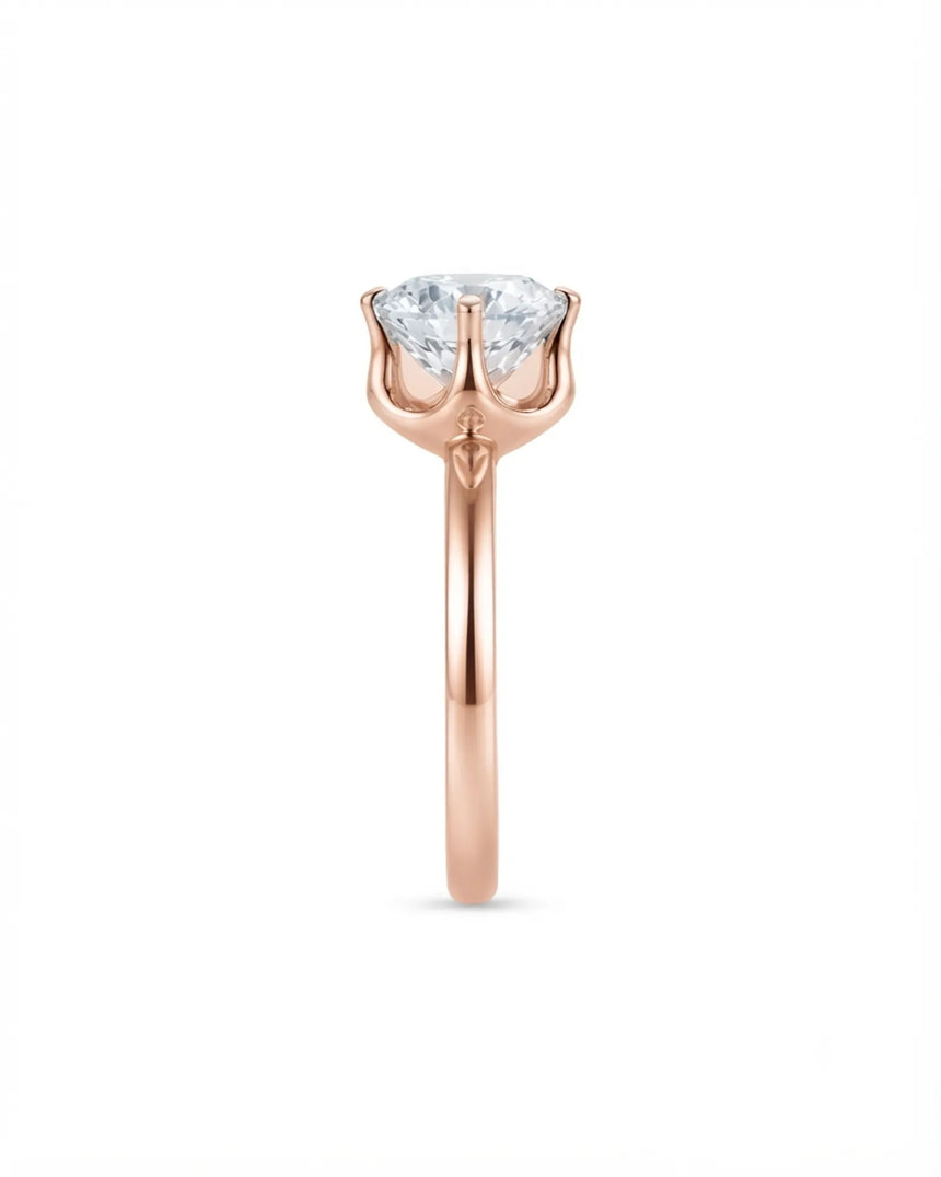 Luxury round moissanite solitaire in 18K rose gold with refined architectural setting | SARATTI