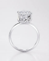 Luxury round moissanite solitaire in 18K white gold with refined architectural setting | SARATTI