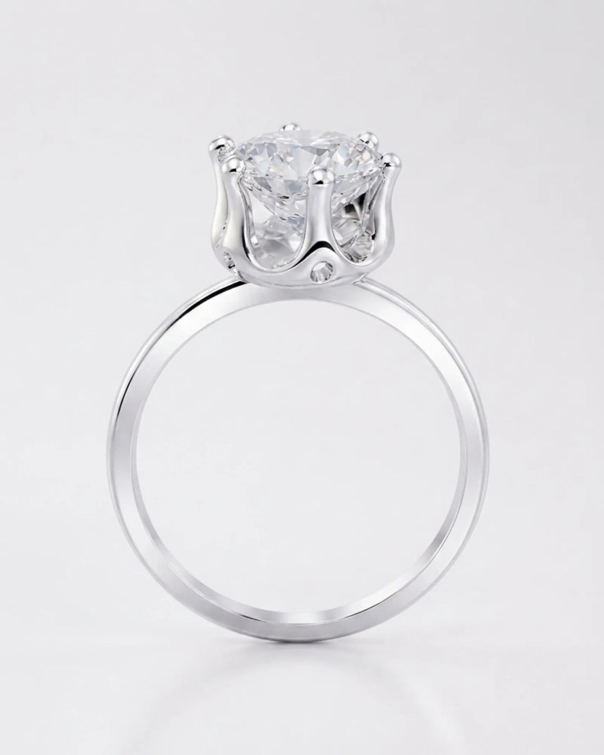 Luxury round moissanite solitaire in 18K white gold with refined architectural setting | SARATTI