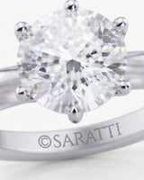 Luxury round moissanite solitaire in platinum with a refined architectural setting | SARATTI