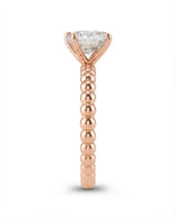 Luxury round moissanite solitaire in rose gold with continuous polished bead band design | SARATTI