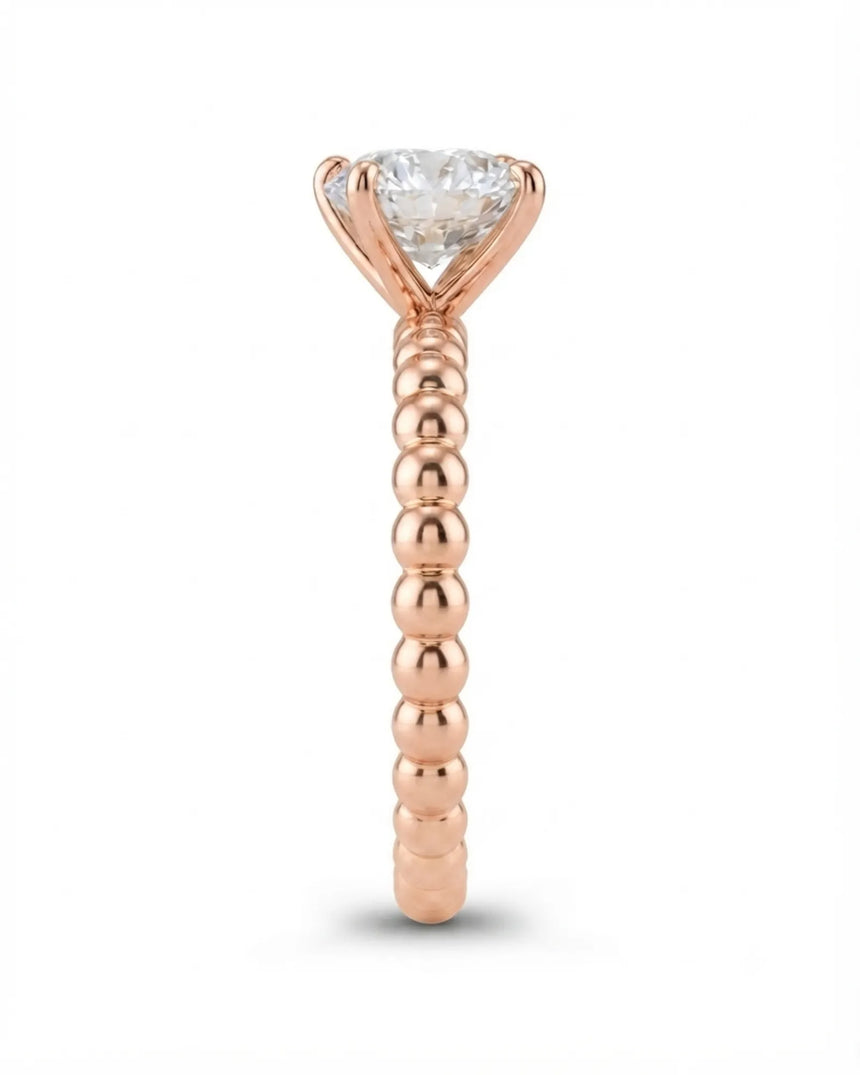 Luxury round moissanite solitaire in rose gold with continuous polished bead band design | SARATTI