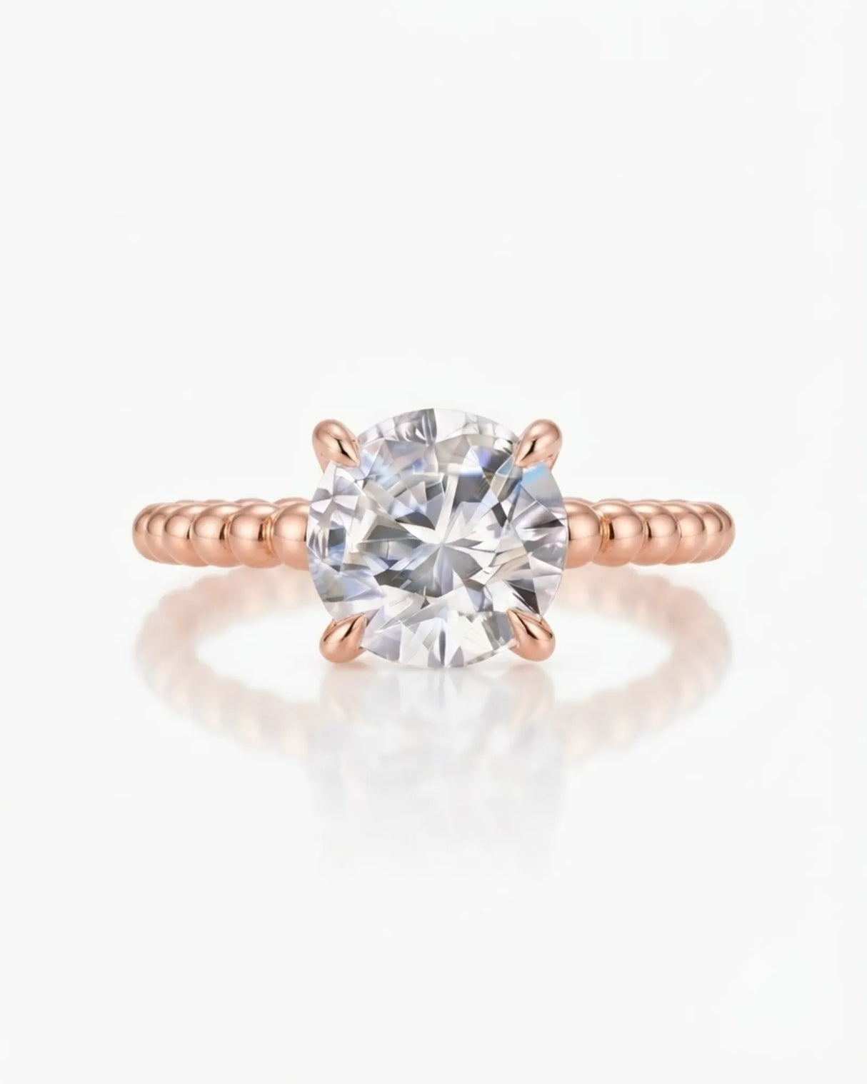 Luxury round moissanite solitaire in rose gold with continuous polished bead band design | SARATTI