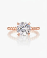 Luxury round moissanite solitaire in rose gold with continuous polished bead band design | SARATTI