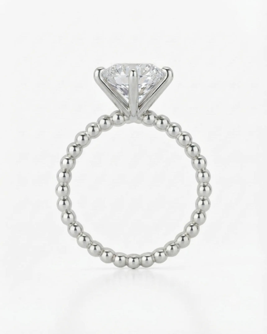 Luxury round moissanite solitaire in white gold with continuous polished bead band design | SARATTI