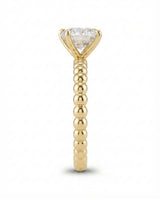 Luxury round moissanite solitaire in yellow gold with continuous polished bead band design | SARATTI