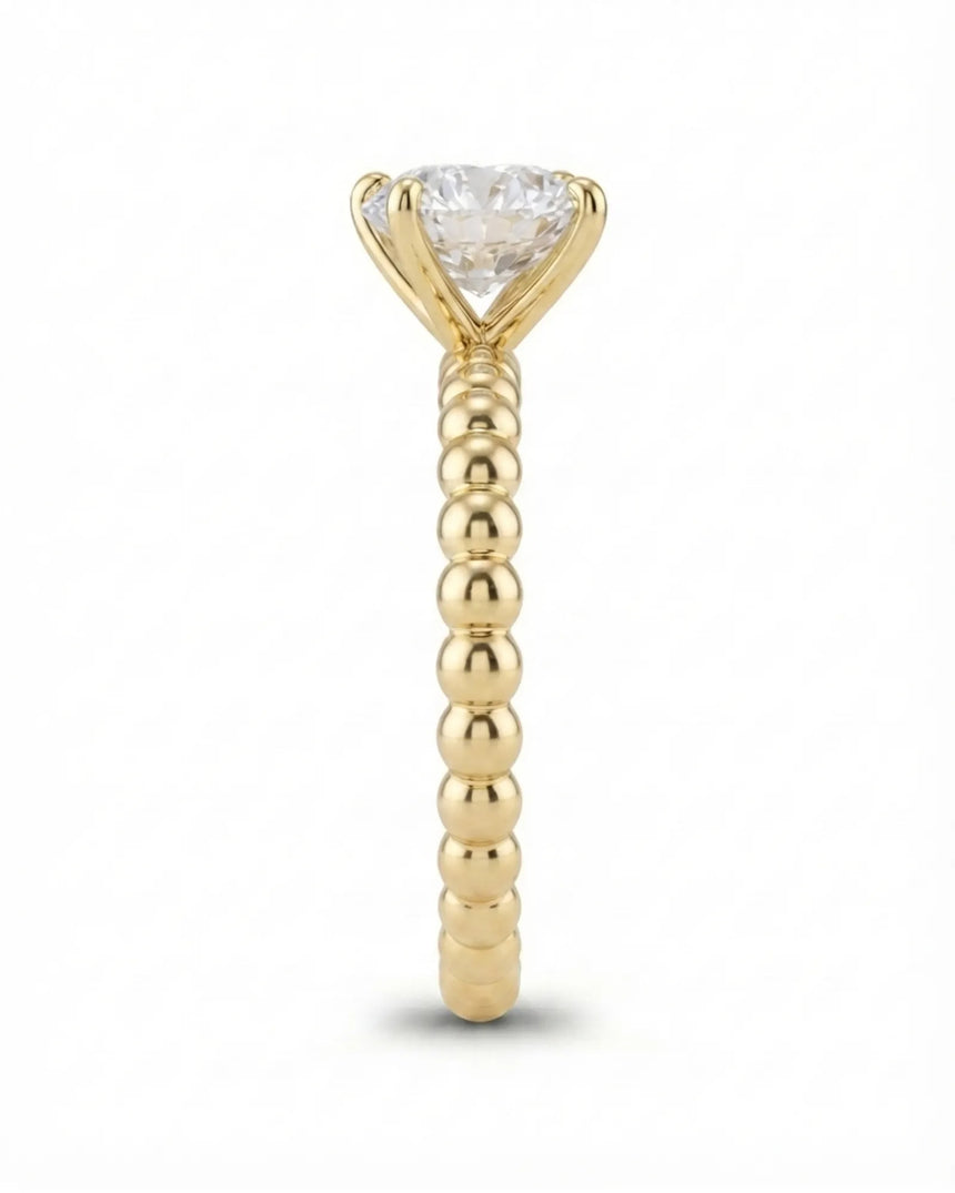 Luxury round moissanite solitaire in yellow gold with continuous polished bead band design | SARATTI