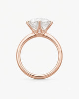 Luxury round moissanite statement ring with high-polish rose gold band and elevated setting | SARATTI.