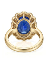 Luxury royal blue sapphire cocktail ring with diamond halo in 18K yellow gold | SARATTI