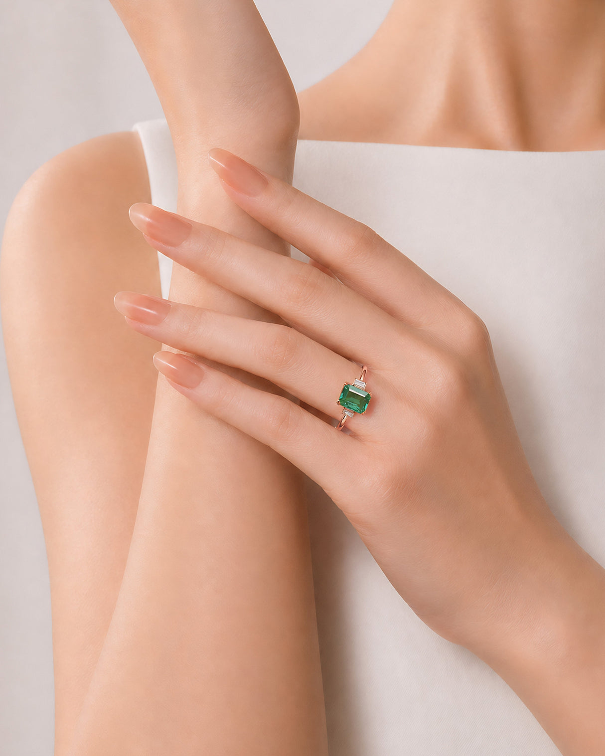 Luxury three stone emerald ring with baguette side diamonds in 18K Rose Gold | SARATTI