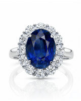 Luxury vintage sapphire halo ring with diamonds in refined 18K white gold | SARATTI