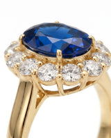 Luxury vintage sapphire halo ring with diamonds in warm 18K yellow gold | SARATTI