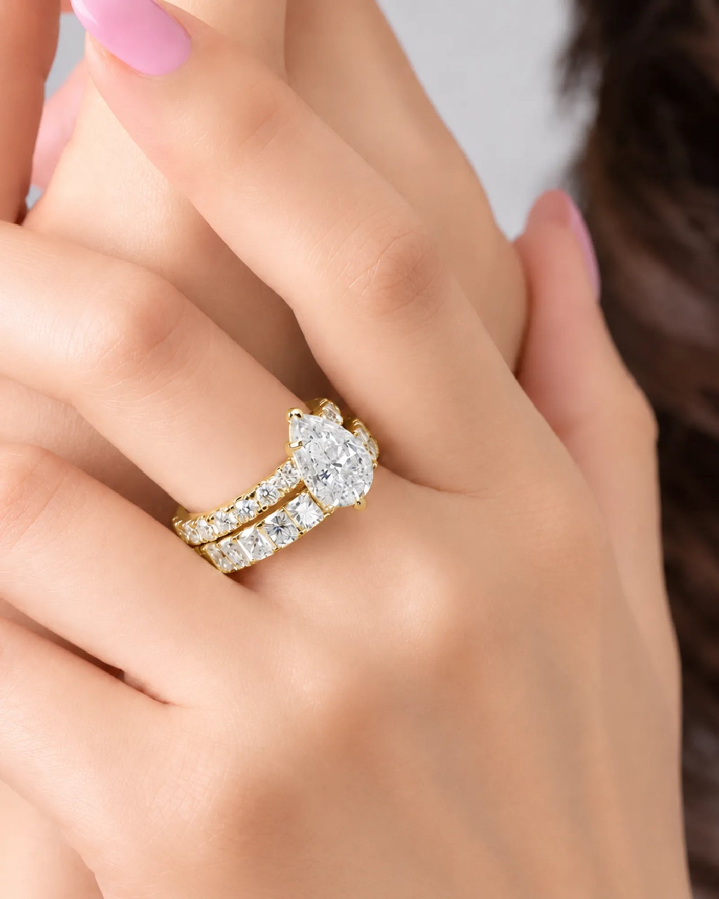 Luxury yellow gold pear cut moissanite ring with luminous side stones and elegant balance | SARATTI.