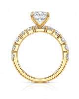 Luxury yellow gold pear cut moissanite ring with luminous side stones and elegant balance | SARATTI