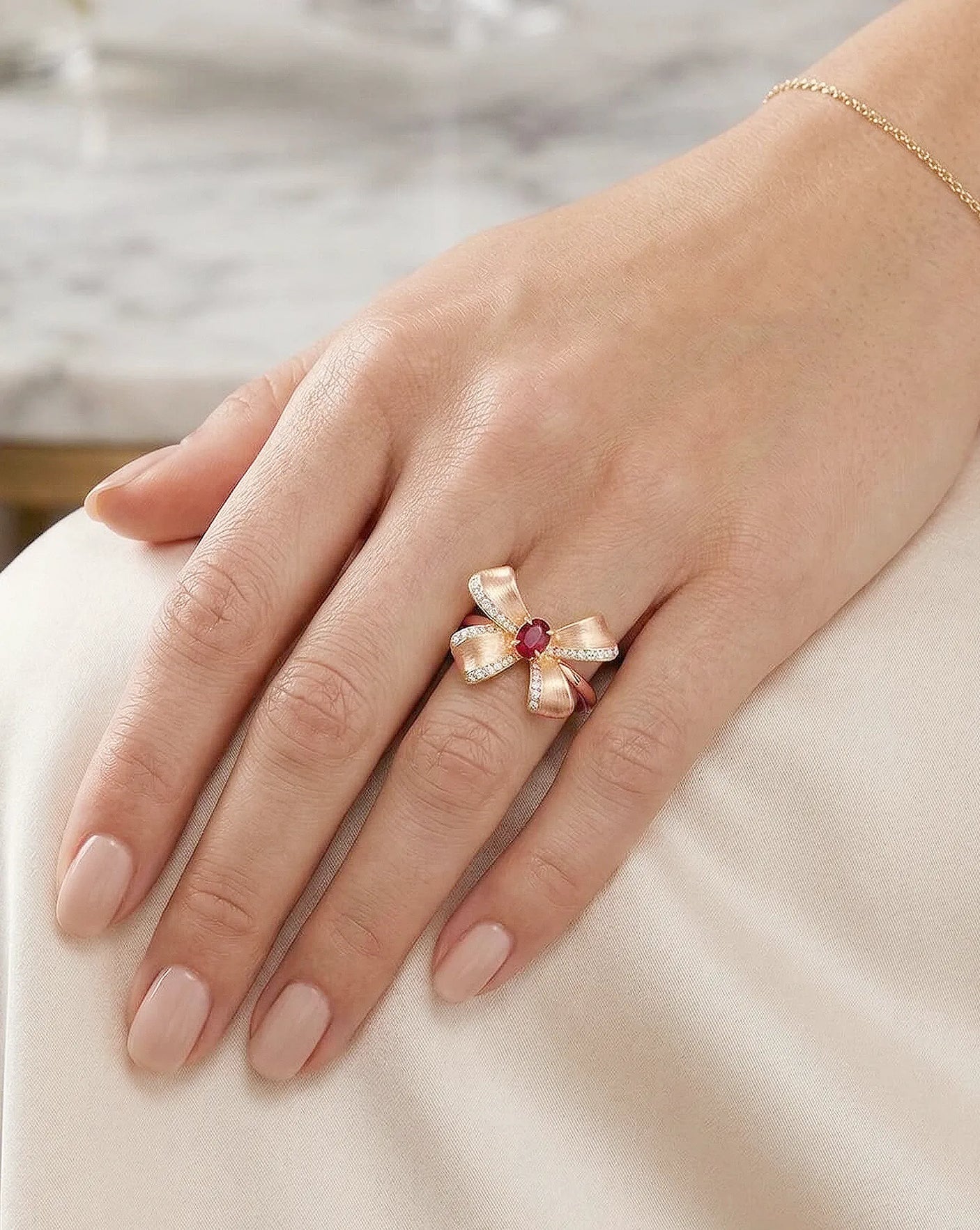 Macro detail pigeon blood ruby and pavé diamonds ribbon design 18K rose gold | SARATTI