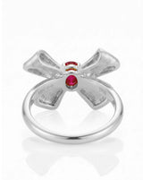 Macro detail pigeon blood ruby and pavé diamonds ribbon design 18K white gold | SARATTI
