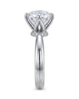Minimal round moissanite ring with sculptural floral setting and polished platinum band | SARATTI