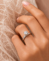 Minimal round moissanite ring with sculptural floral setting and polished white gold band | SARATTI