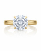 Minimal round moissanite ring with sculptural floral setting and polished yellow gold band | SARATTI