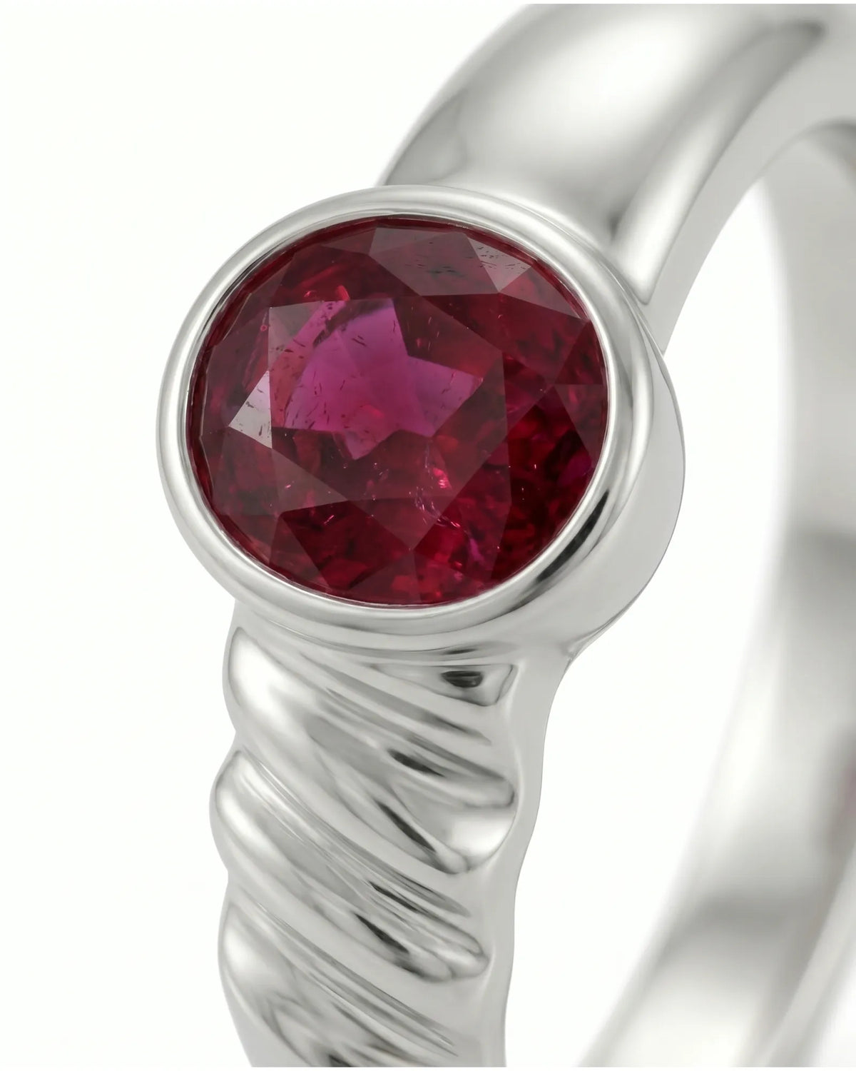 Minimalist ruby engagement ring in platinum with secure oval bezel setting | SARATTI