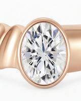 Modern bezel set moissanite ring with triple wave shank in polished 18K rose gold | SARATTI