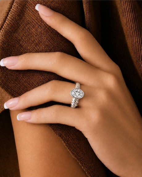 Modern bezel set moissanite ring with triple wave shank in polished 18K white gold | SARATTI