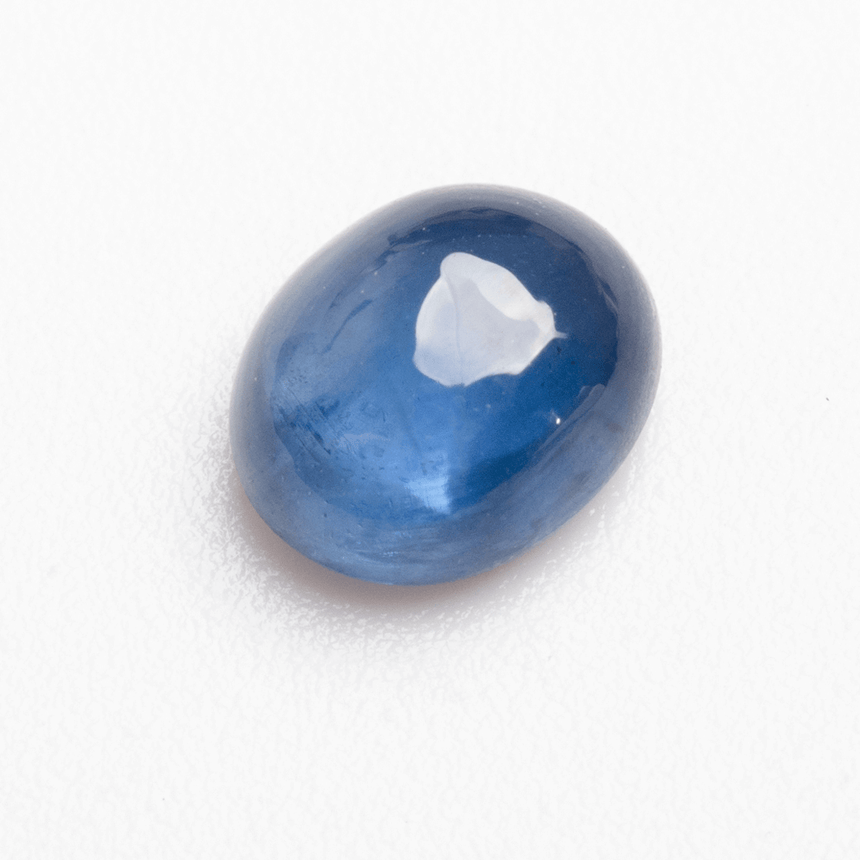 Natural 0.89 carat blue sapphire cabochon photographed on white background | SARATTI