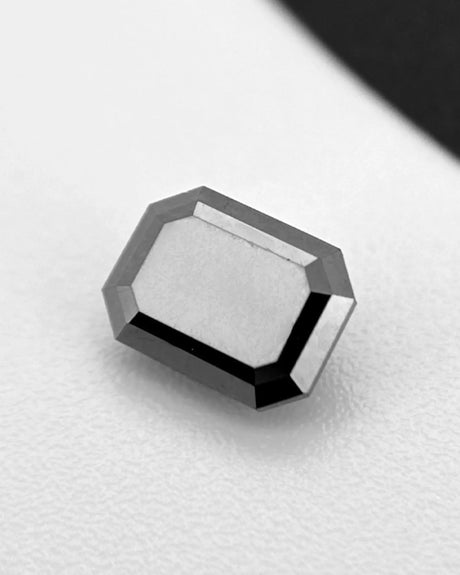 Natural Black emerald-cut diamond with polished dark surface | SARATTI