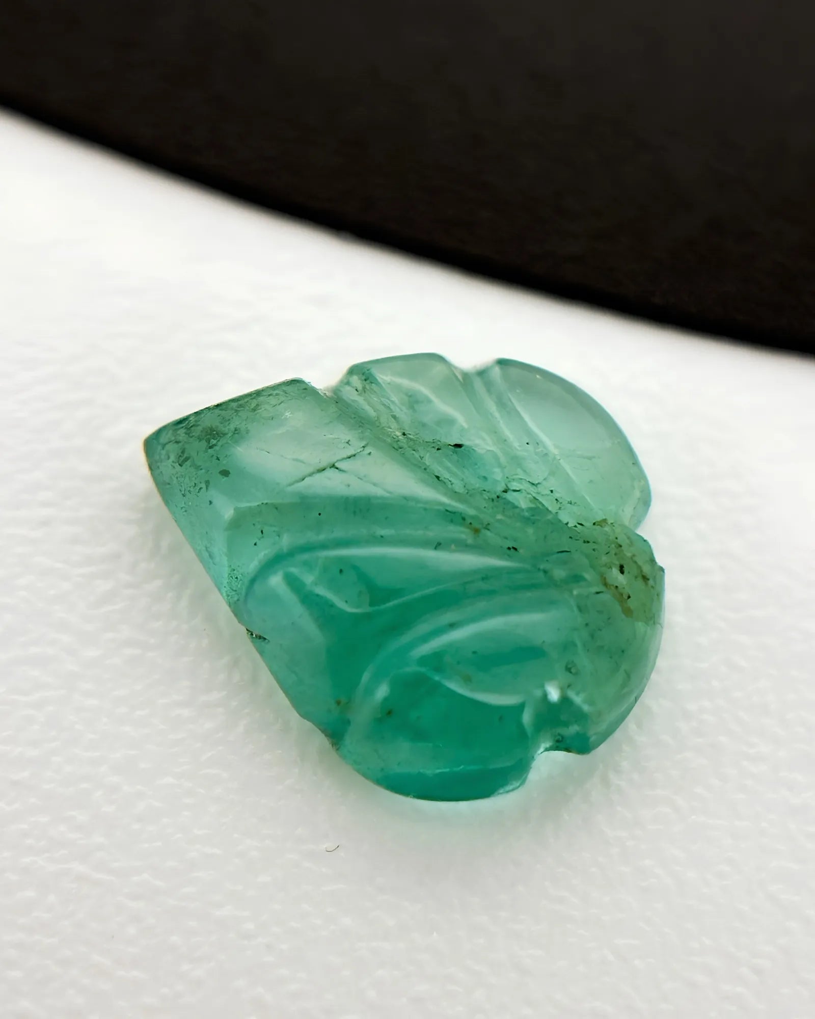 Natural Emerald carved leaf loose gemstone shown from an alternate angle - SARATTI