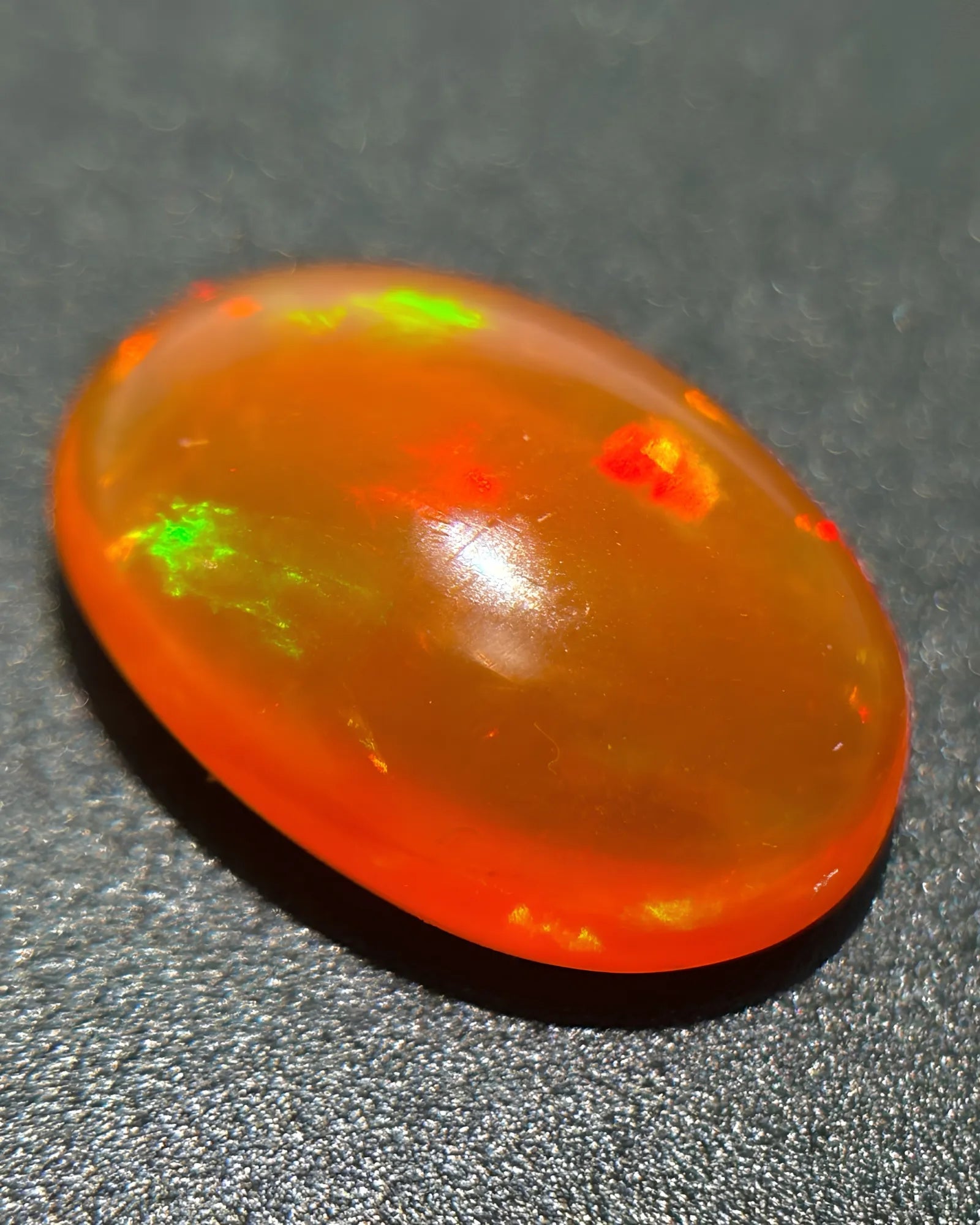 Natural Fire Opal close-up showing warm orange bodycolour and green colour flashes | SARATTI