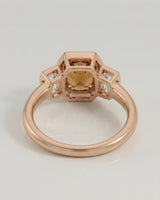 Natural Imperial Topaz oval bezel setting with diamond side stones in 18K rose gold | SARATTI