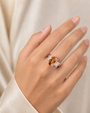 Natural Imperial Topaz oval setting with diamond side stones in 18K rose gold | SARATTI