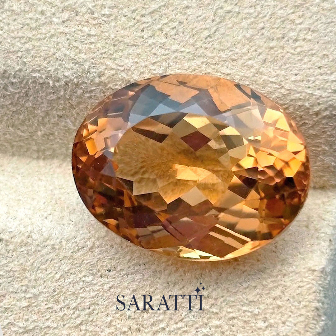 Natural champagne Imperial Topaz oval faceted gemstone top view | SARATTI