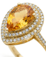 Natural citrine engagement ring with pear silhouette, double diamond halo, and 18K yellow gold band | SARATTI