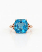 Natural cushion Swiss Blue topaz ring framed by sculpted diamond details in 18K rose gold | SARATTI