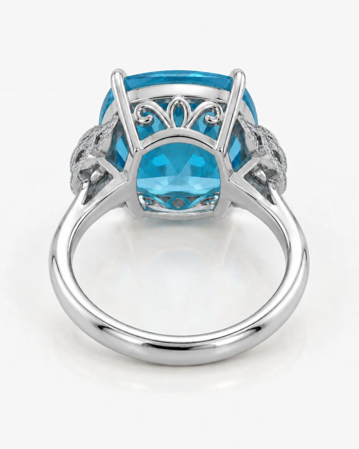 Natural cushion Swiss Blue topaz ring framed by sculpted diamond details in platinum | SARATTI