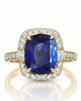 Natural cushion sapphire ring framed by bright round diamonds in 18K yellow gold | SARATTI